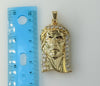 Large gold plated pendant featuring a detailed Jesus icon.
Close-up of a gold plated pendant depicting Jesus' face.
Imag