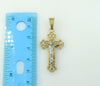 A gold plated Tri-Color Cross pendant with intricate details and design.
A delicate gold plated Cross pendant featuring
