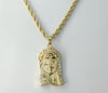 Gold plated braided chain Jesus pendant necklace with rope chain detail.