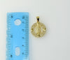 A small Virgin Mary figurine pendant with delicate details.

A small, intricately designed Virgin Mary figurine pendant.