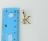Delicate gold plated pendant features a small letter "K" design.
Dainty gold plated pendant showcases a tiny, intricate