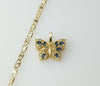 A dainty gold plated flat mariner anchor chain necklace with a butterfly pendant.