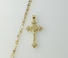 A gold plated mariner anchor chain necklace with a small cross pendant.

A gold plated chain necklace with a small cross
