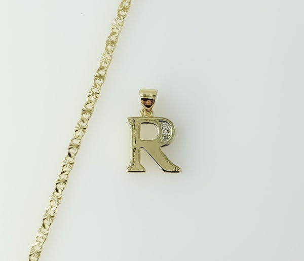 Gold plated star chain necklace with dainty letter "R" pendant attached.