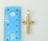A small gold-plated cross pendant with intricate details
A delicate gold-plated Christian cross pendant
A gold-plated
