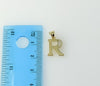 An intricately designed gold plated flat anchor pendant with letter R.

A 3mm flat gold plated anchor pendant with a sma