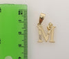 A small gold plated pendant featuring a stylized letter "M".
A gold plated pendant in the shape of a multicolored Saint